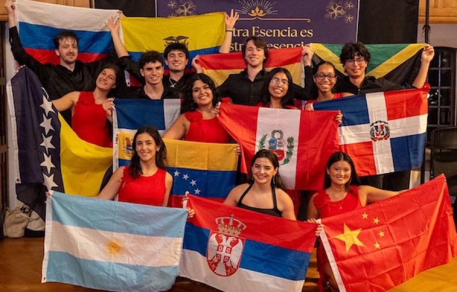 Members of Salsa Palante posing for a picture with different country flags