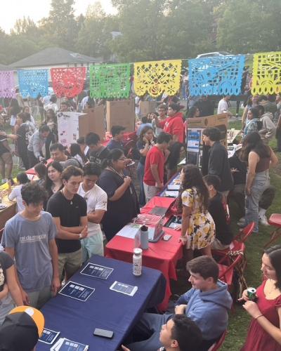 Students perusing tables in a yard event