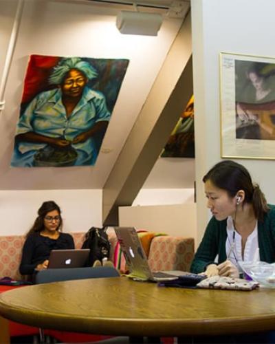 A still image of two students working and reading sitting at a table