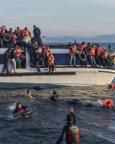 Volunteers from Proactiva Open Arms aid refugees arriving from Turkey to Skala Sykamias, Greece.